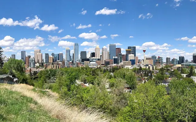 Downtown Calgary skyline above green parkland
