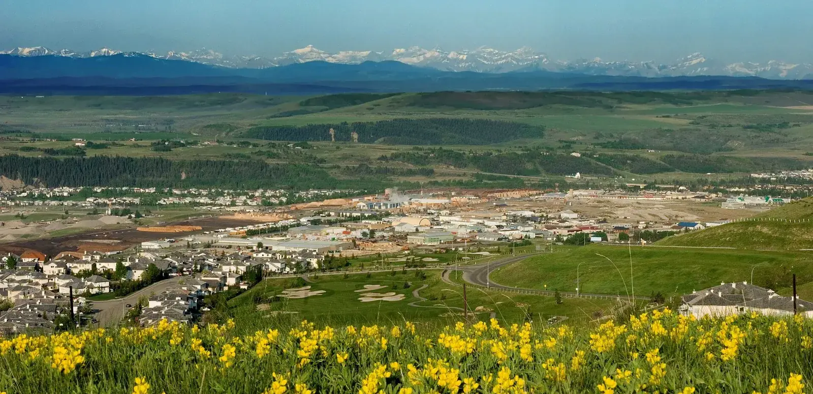 View west over Cochrane from the Glen Eagles hillside toward the Rocky Mountains